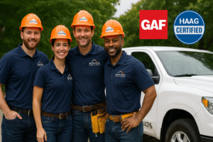 Four Rooftops Unlimited roofing professionals in branded gear standing beside a company truck with GAF and HAAG Certified logos visible.